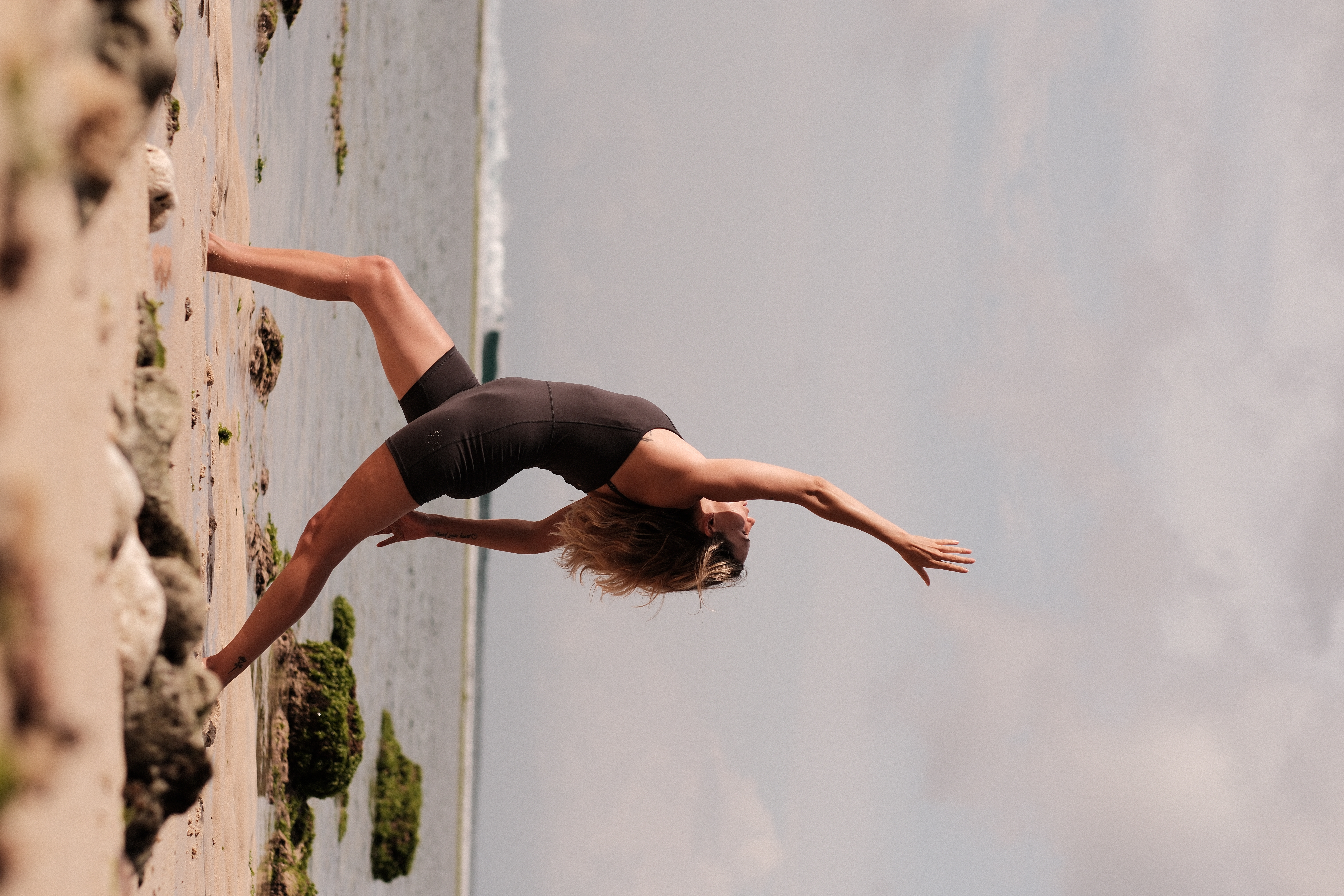 Sabrina practicing yoga on the beach